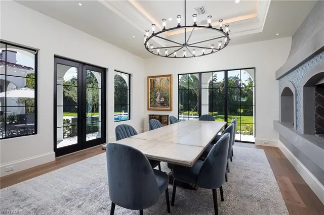 a view of a dining room with furniture large windows and wooden floor