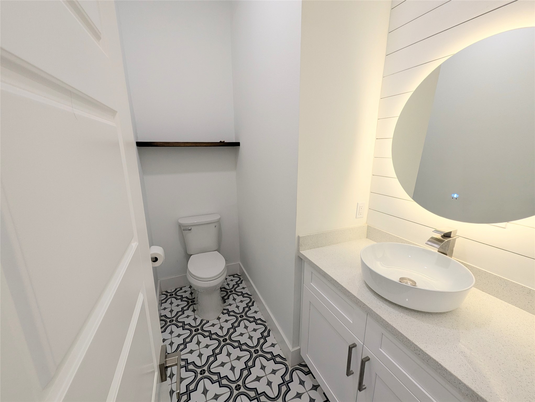 4913 Fisk Street Houston, TX 77009 - Photo 8 of 27 a bathroom with a granite countertop sink toilet and a mirror