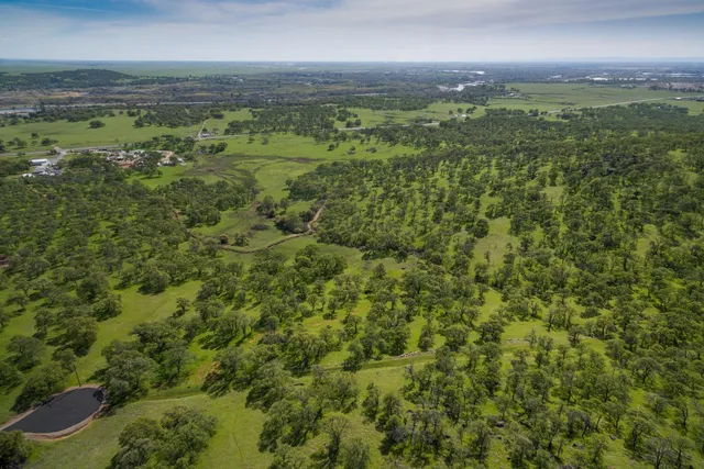 a view of a green field with an ocean view