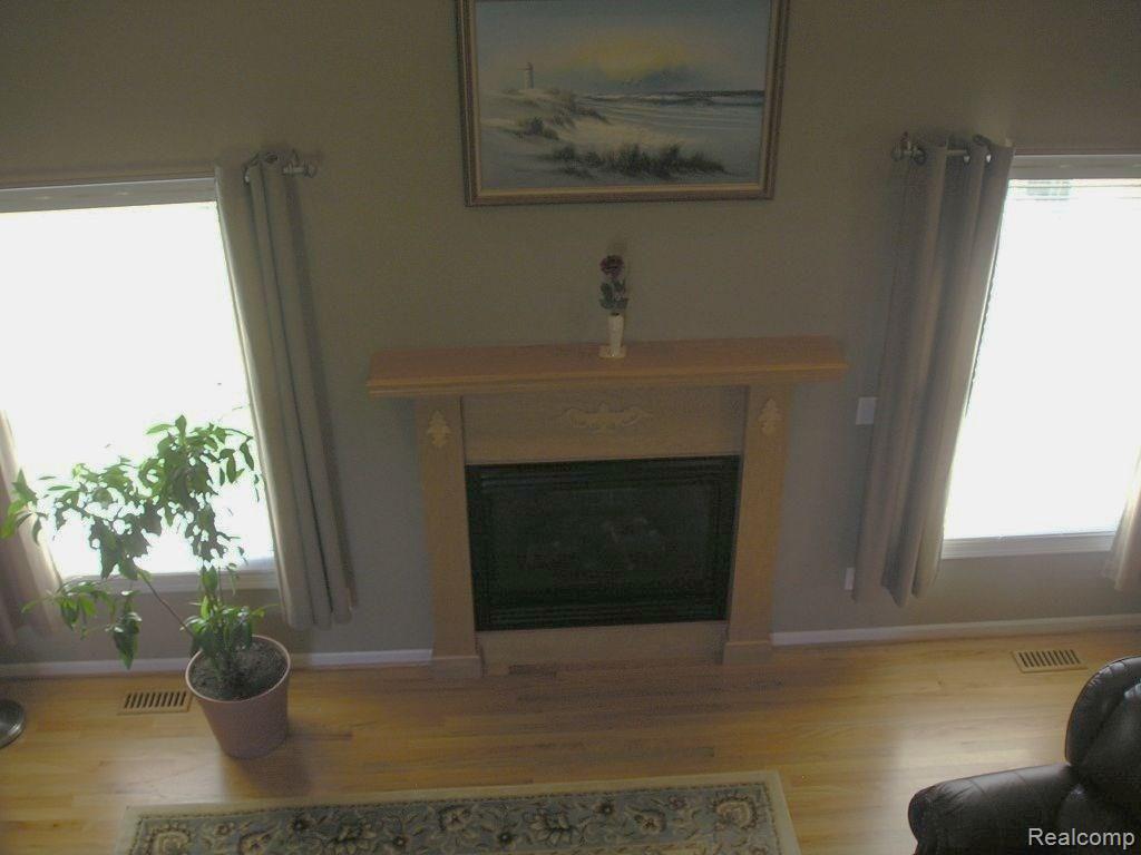 4025 Belle Ridge Drive Dryden, MI 48428 - Photo 22 of 43 Great room fire place from second floor bridge.