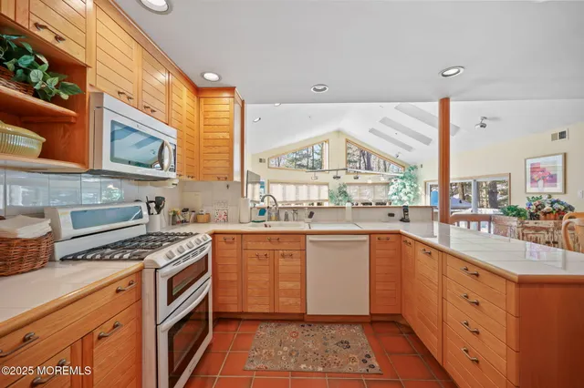 a living room with furniture a flat screen tv and a floor to ceiling window