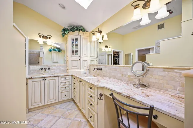 a living room with furniture and painting on the wall