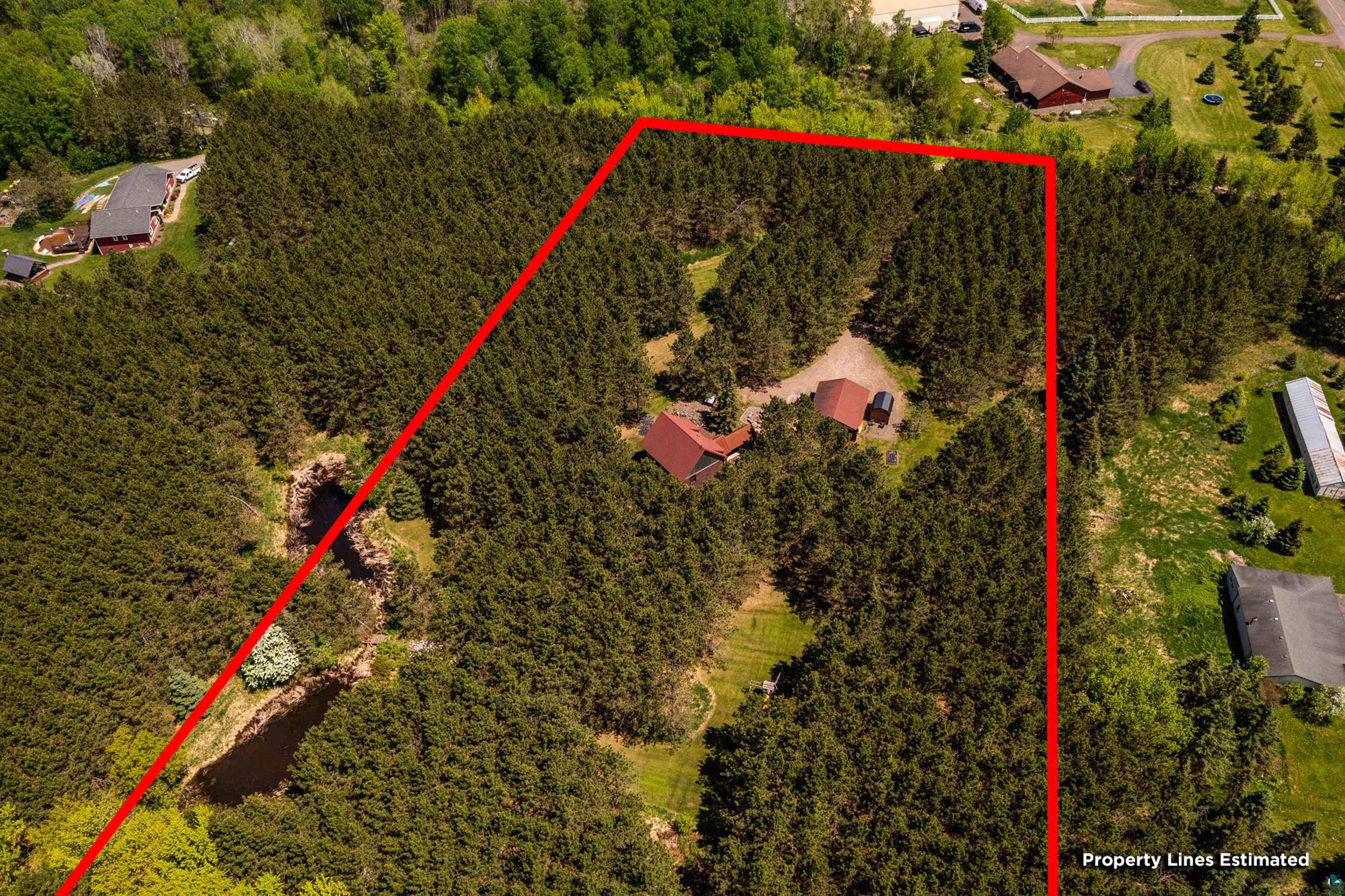 75 East Stark Road Esko, MN 55733 - Photo 80 of 87 Extensive wooded acreage featuring a main residence with a red roof, a detached auxiliary building, and a natural pond