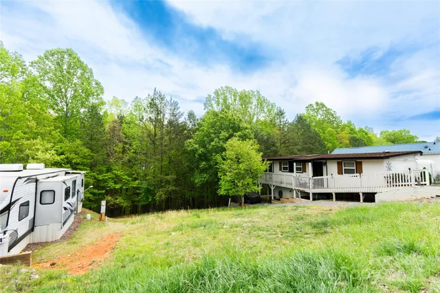 a view of a house with pool and garden