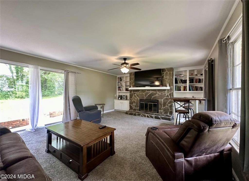 2960 Stuart Drive Macon, GA 31204 - Photo 2 of 10 a living room with furniture a fireplace and a large window