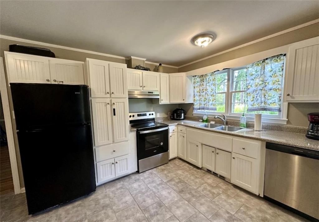 2960 Stuart Drive Macon, GA 31204 - Photo 5 of 10 a kitchen with granite countertop white cabinets and refrigerator
