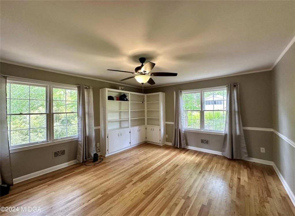 2960 Stuart Drive Macon, GA 31204 - Photo 6 of 10 a view of an empty room with a window and wooden floor