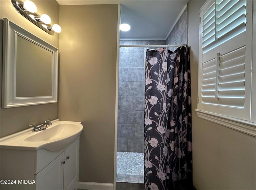 2960 Stuart Drive Macon, GA 31204 - Photo 7 of 10 a bathroom with a sink and a mirror