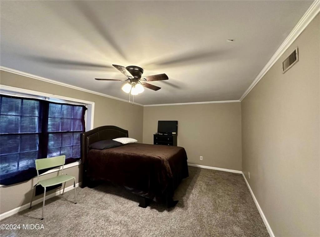 2960 Stuart Drive Macon, GA 31204 - Photo 10 of 10 a bedroom with a bed a lamp and a closet