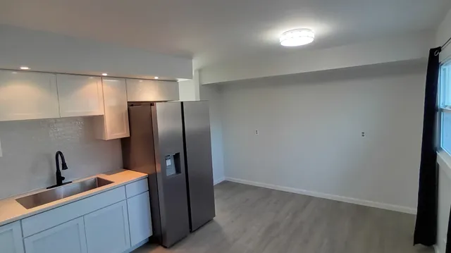 a kitchen with stainless steel appliances a refrigerator and sink