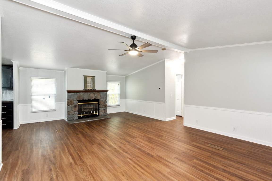 11201 New Zion Road Christiana, TN 37037 - Photo 3 of 19 an empty room with wooden floor fireplace and windows