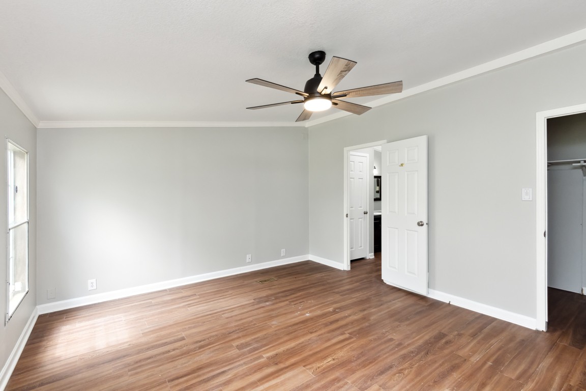 11201 New Zion Road Christiana, TN 37037 - Photo 6 of 19 an empty room with wooden floor fan and windows