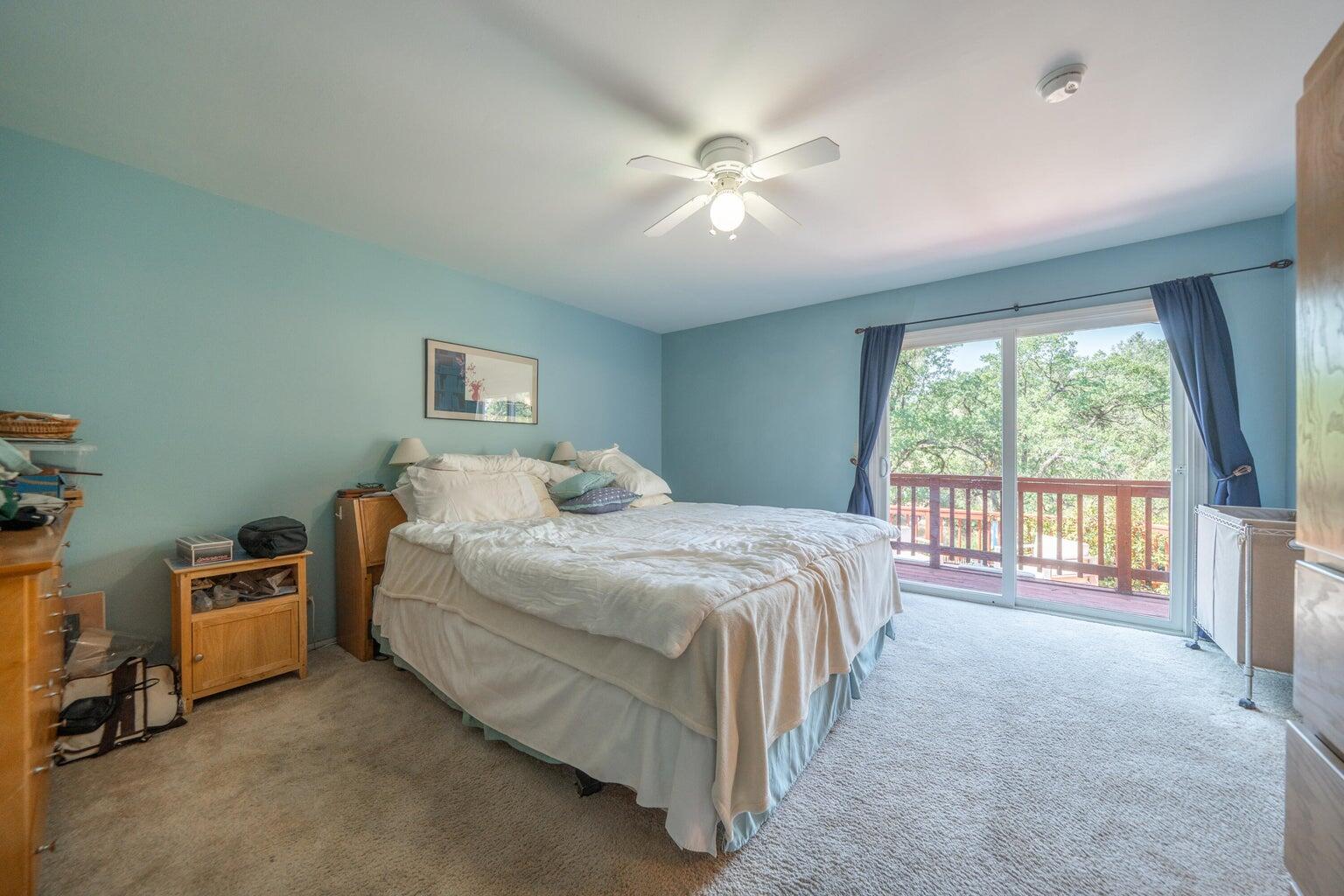 8846 Goldstone Lane Redding, CA 96001 - Photo 29 of 64 a spacious bedroom with a bed and a large window