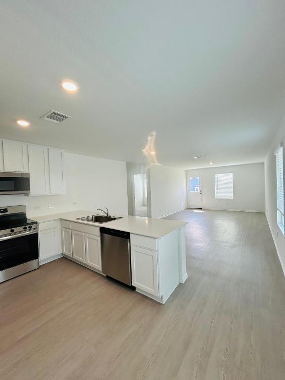 521 Cattle Queen Road Jarrell, TX 76537 - Photo 16 of 16 a kitchen with a cabinets and white appliances