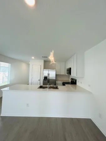 a kitchen with a cabinets and white appliances