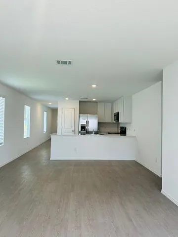 a view of hallway with stairs and wooden floor