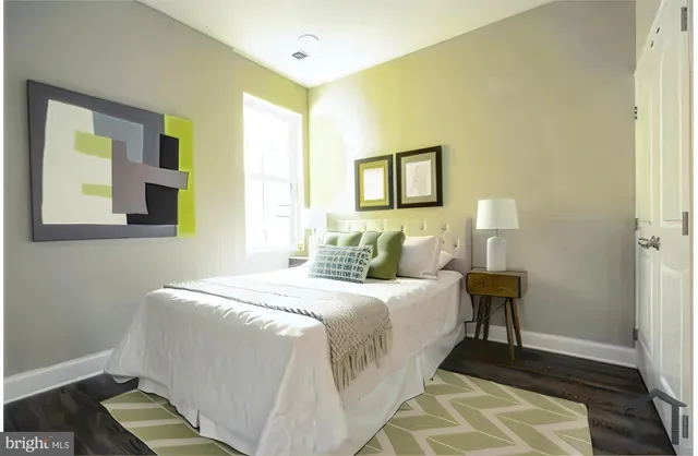 a bedroom with bed and a night stand