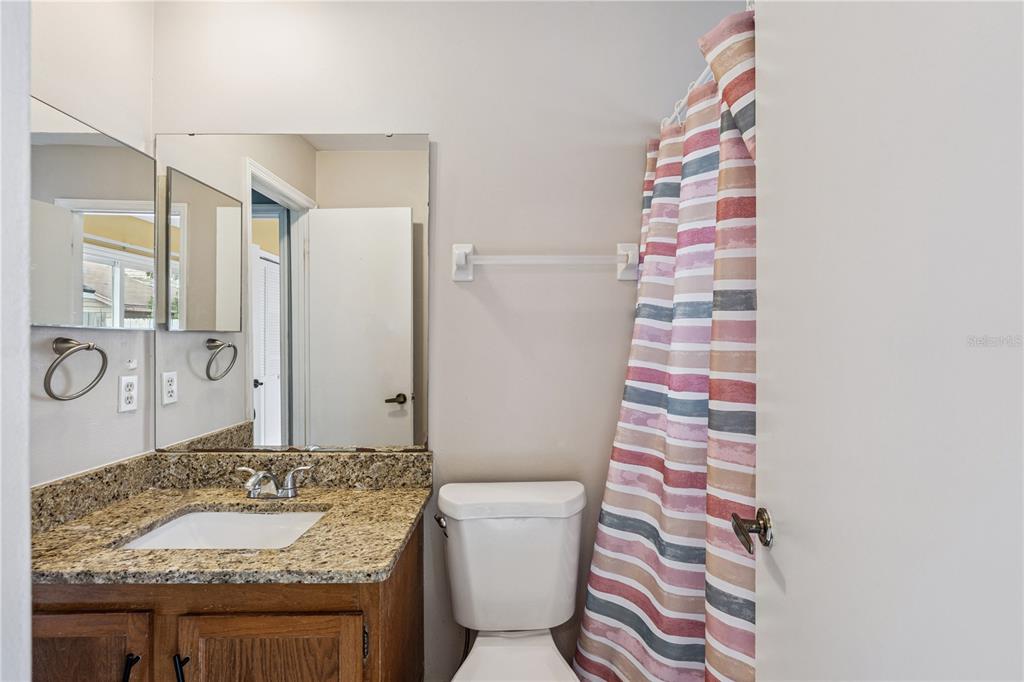 518 Torrey Avenue Altamonte Springs, FL 32714 - Photo 13 of 27 a bathroom with a granite countertop sink and a mirror