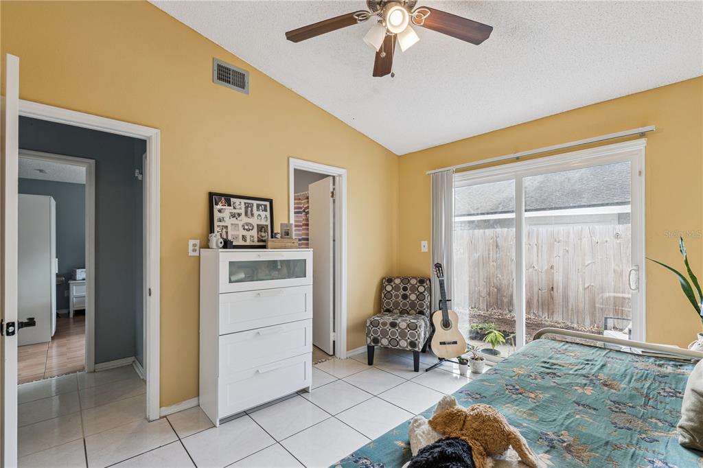 518 Torrey Avenue Altamonte Springs, FL 32714 - Photo 17 of 27 a bedroom with a bed and a chandelier