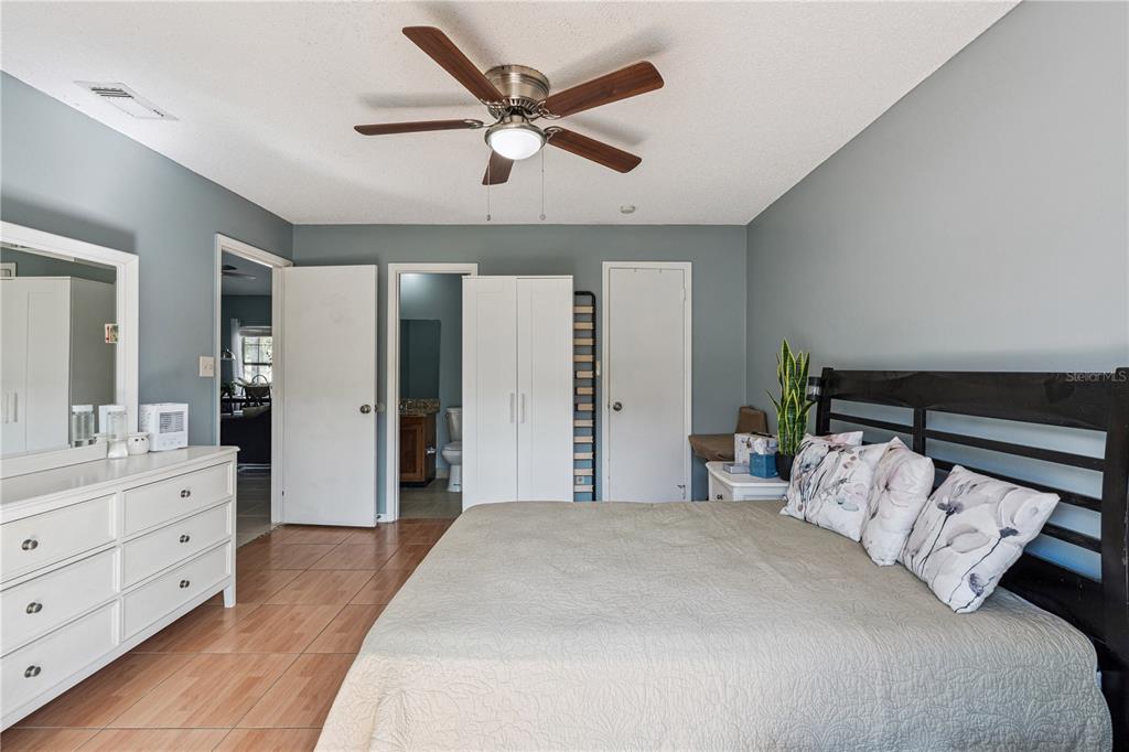 518 Torrey Avenue Altamonte Springs, FL 32714 - Photo 20 of 27 a bedroom with a large bed and a chandelier