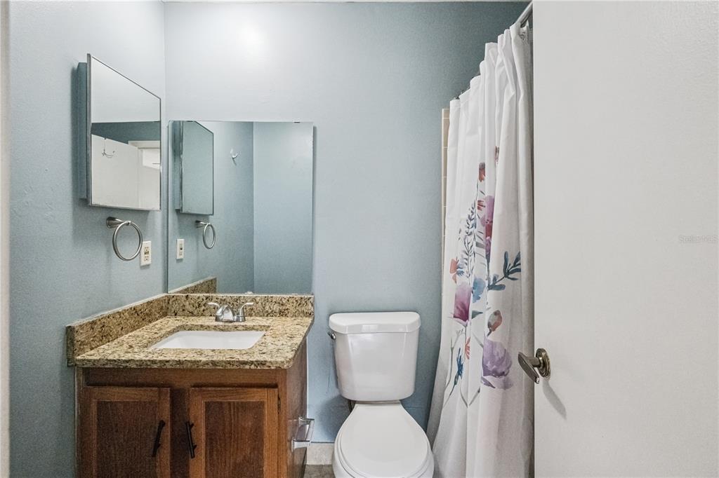 518 Torrey Avenue Altamonte Springs, FL 32714 - Photo 21 of 27 a bathroom with a granite countertop toilet sink and mirror