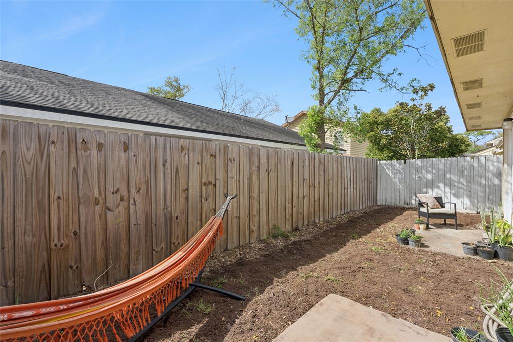 518 Torrey Avenue Altamonte Springs, FL 32714 - Photo 23 of 27 a backyard of a house with chairs and wooden fence