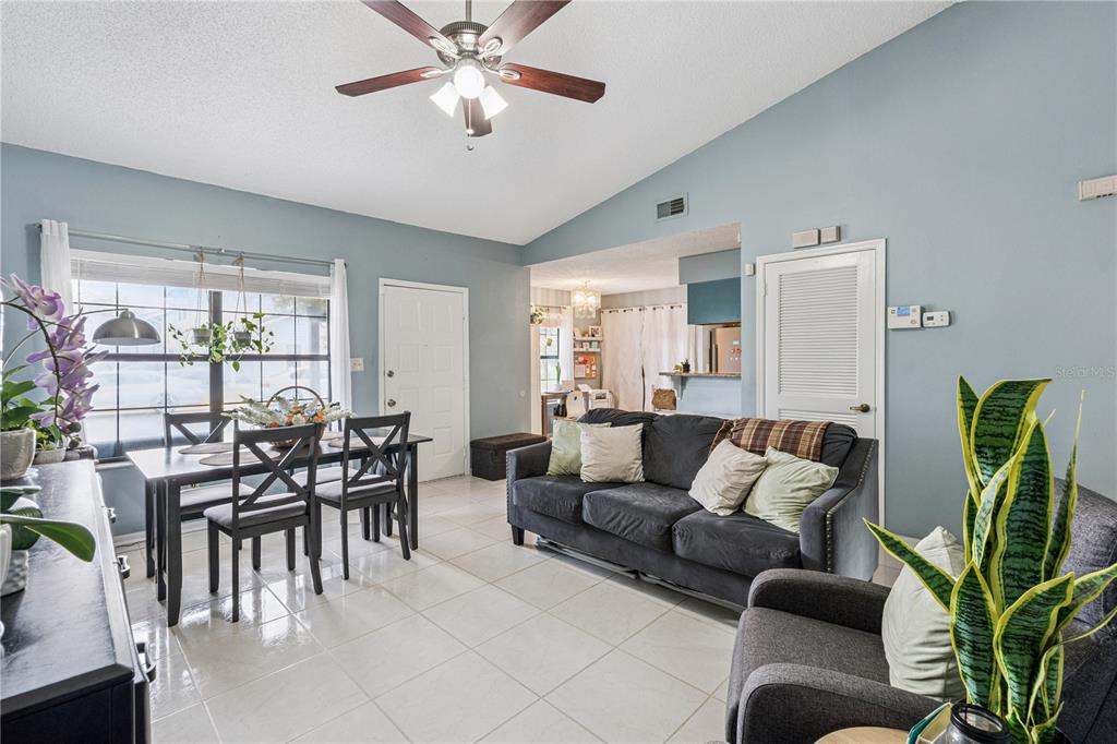 518 Torrey Avenue Altamonte Springs, FL 32714 - Photo 6 of 27 a living room with furniture a dining table and a potted plant