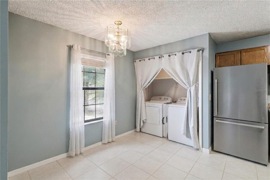 518 Torrey Avenue Altamonte Springs, FL 32714 - Photo 7 of 27 a kitchen with white cabinets and refrigerator