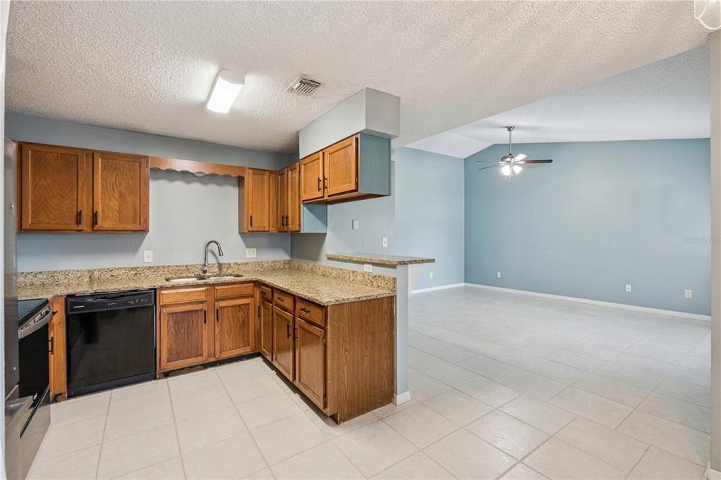 518 Torrey Avenue Altamonte Springs, FL 32714 - Photo 10 of 27 a kitchen with stainless steel appliances granite countertop a stove and a sink