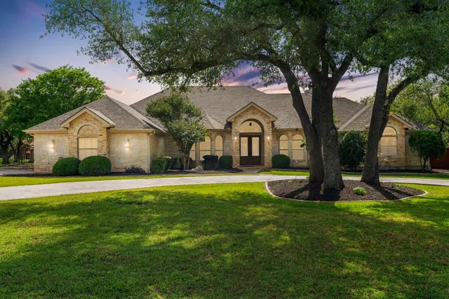 a front view of a house with garden