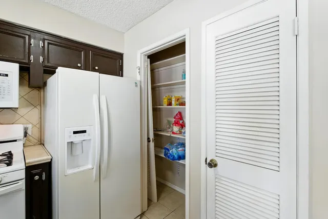 a view of hallway with closet and wooden floor