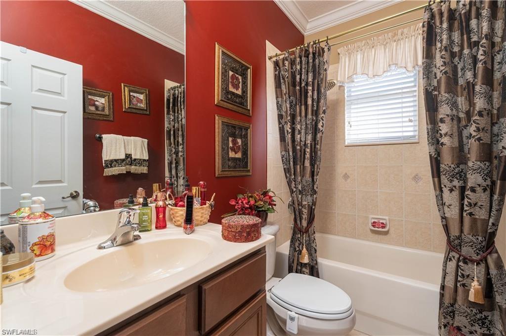 1562 Double Eagle Trail Naples, FL 34120 - Photo 11 of 13 a bathroom with a sink a toilet a tub and shower