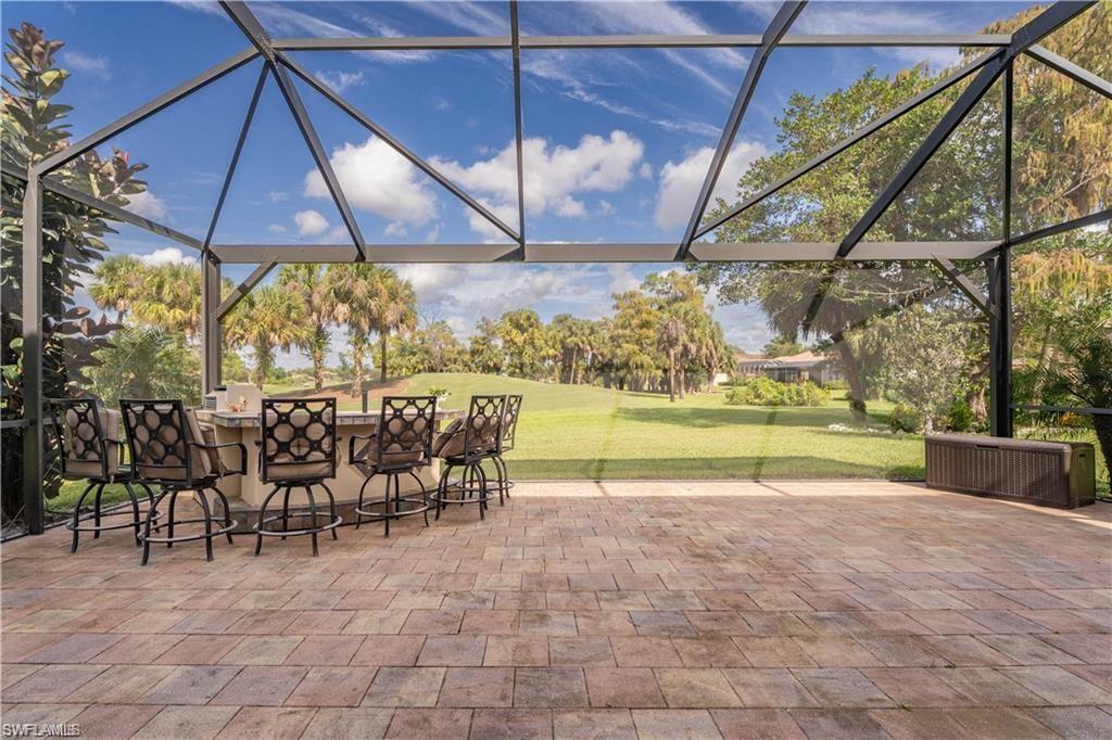 1562 Double Eagle Trail Naples, FL 34120 - Photo 2 of 13 a view of a swimming pool with a patio