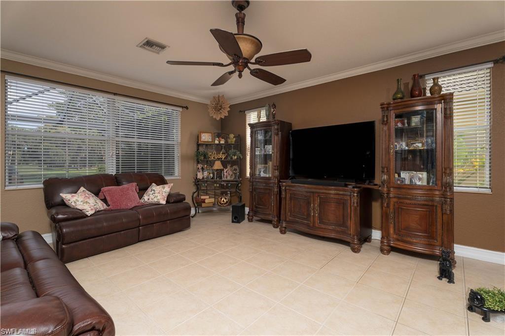 1562 Double Eagle Trail Naples, FL 34120 - Photo 4 of 13 a living room with furniture and a flat screen tv