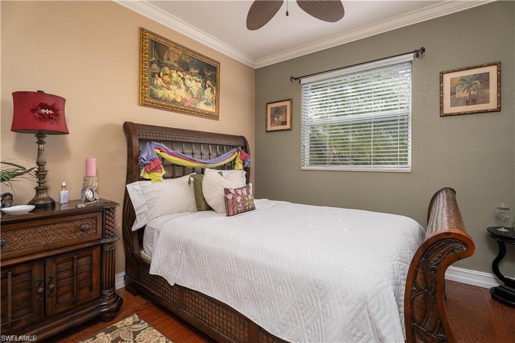 1562 Double Eagle Trail Naples, FL 34120 - Photo 8 of 13 a bedroom with a bed and a dresser