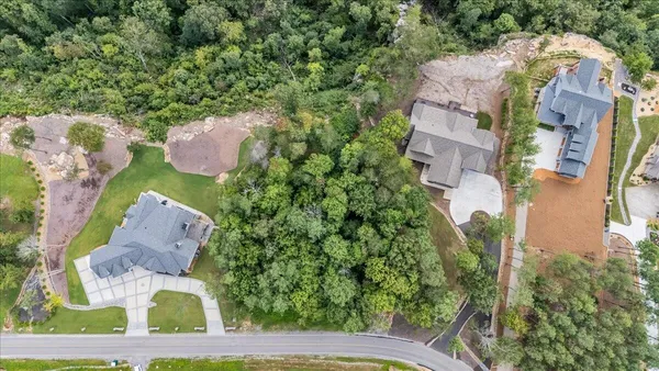 an aerial view of a house with a garden and trees