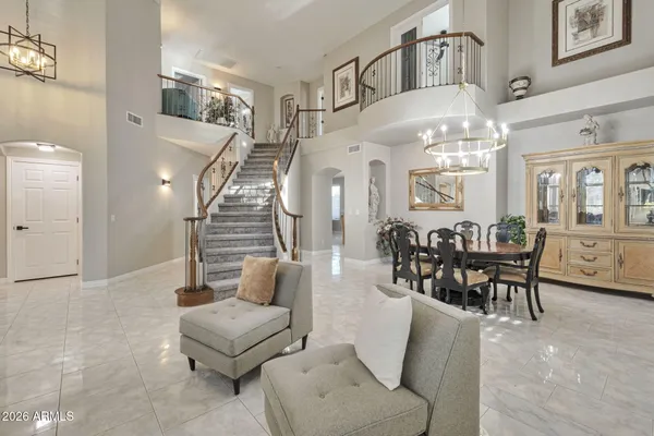 a living room with furniture and a chandelier