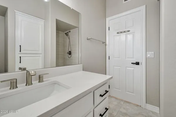 a backyard of a house with large trees and plants