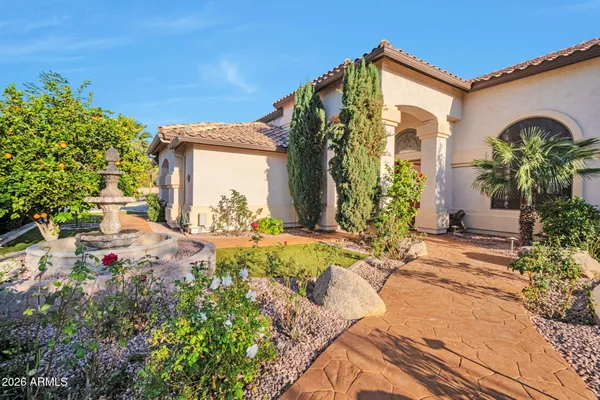 an aerial view of a house with a yard and a large tree