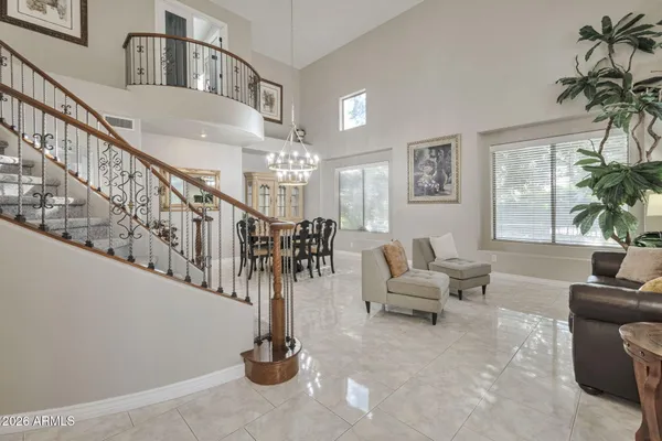 a living room with furniture and a chandelier