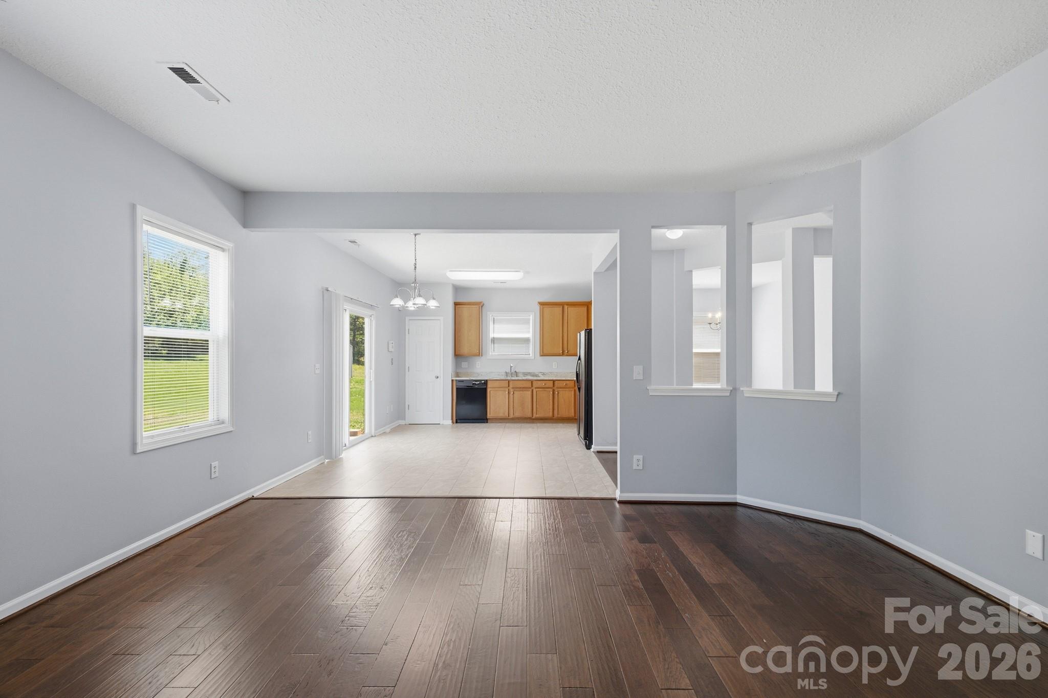 6404 Trotters Ridge Road Charlotte, NC 28227 - Photo 11 of 29 a view of an empty room with wooden floor and a window