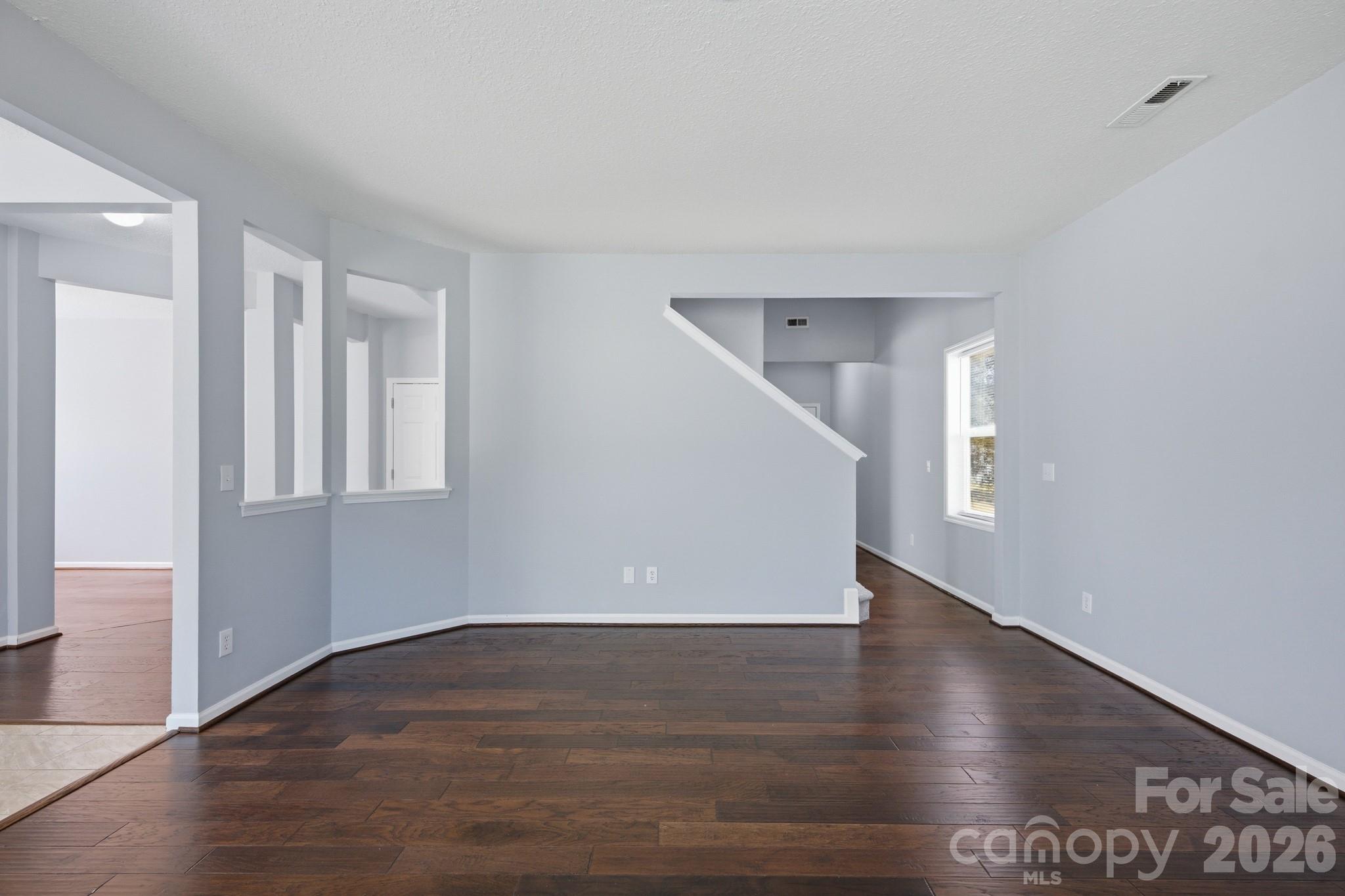 6404 Trotters Ridge Road Charlotte, NC 28227 - Photo 12 of 29 a view of an empty room with wooden floor and a window
