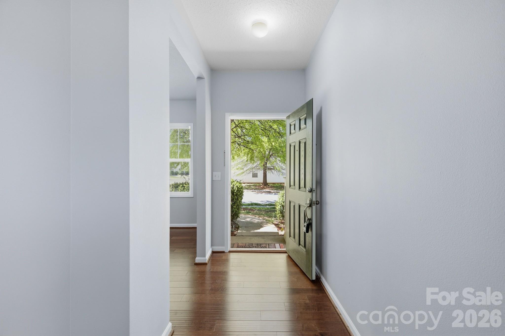 6404 Trotters Ridge Road Charlotte, NC 28227 - Photo 13 of 29 a view of an empty room with wooden floor and a window