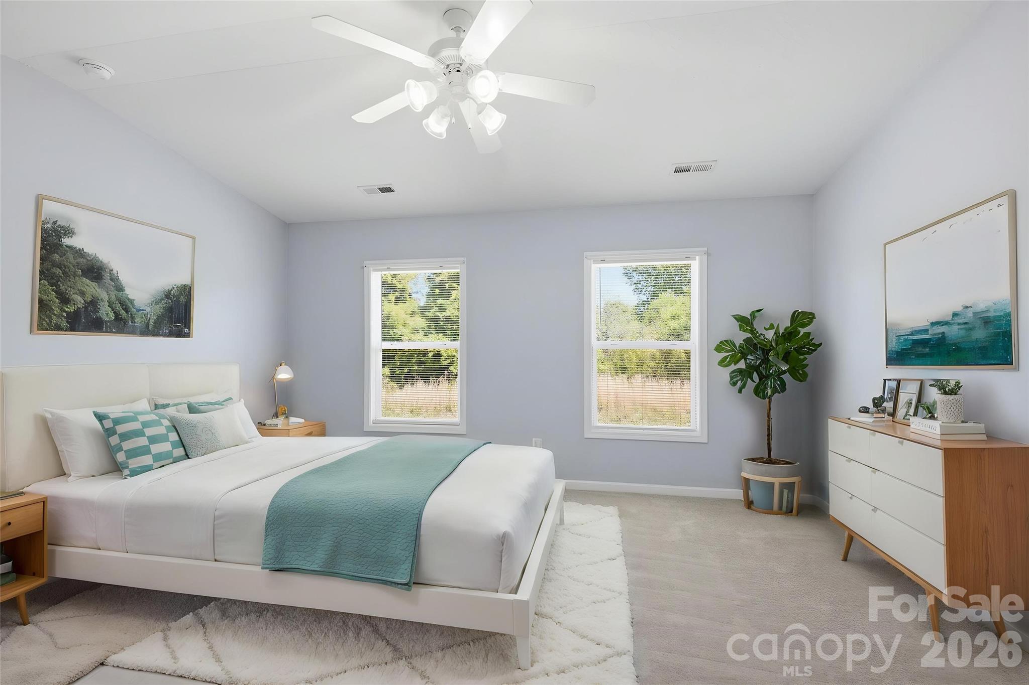 6404 Trotters Ridge Road Charlotte, NC 28227 - Photo 18 of 29 a bedroom with a large bed and a chandelier