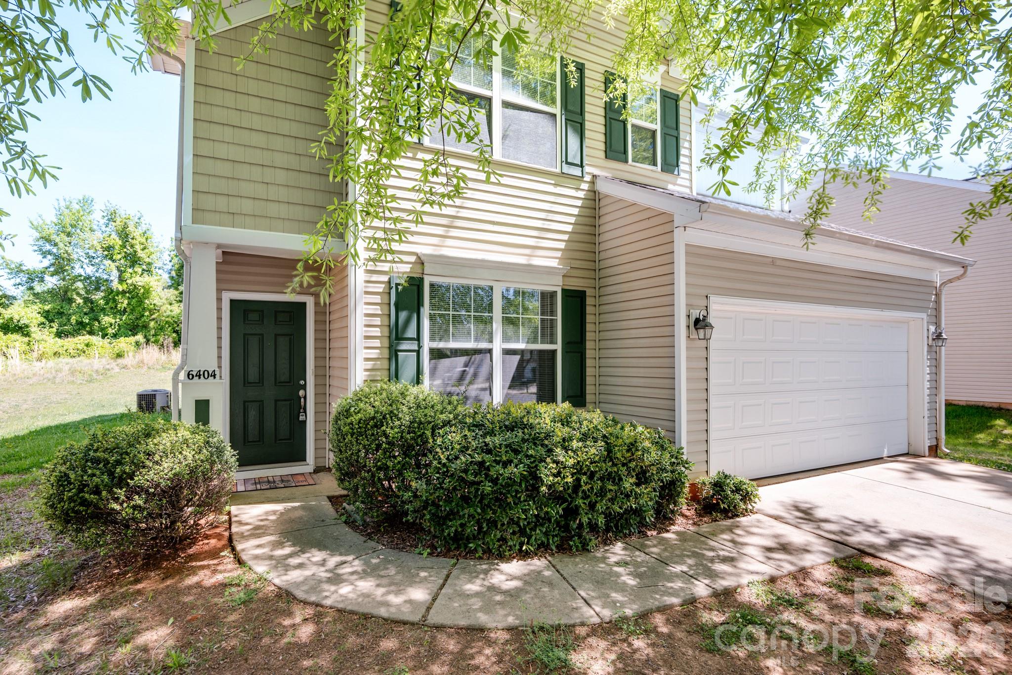 6404 Trotters Ridge Road Charlotte, NC 28227 - Photo 2 of 29 a front view of a house with garden