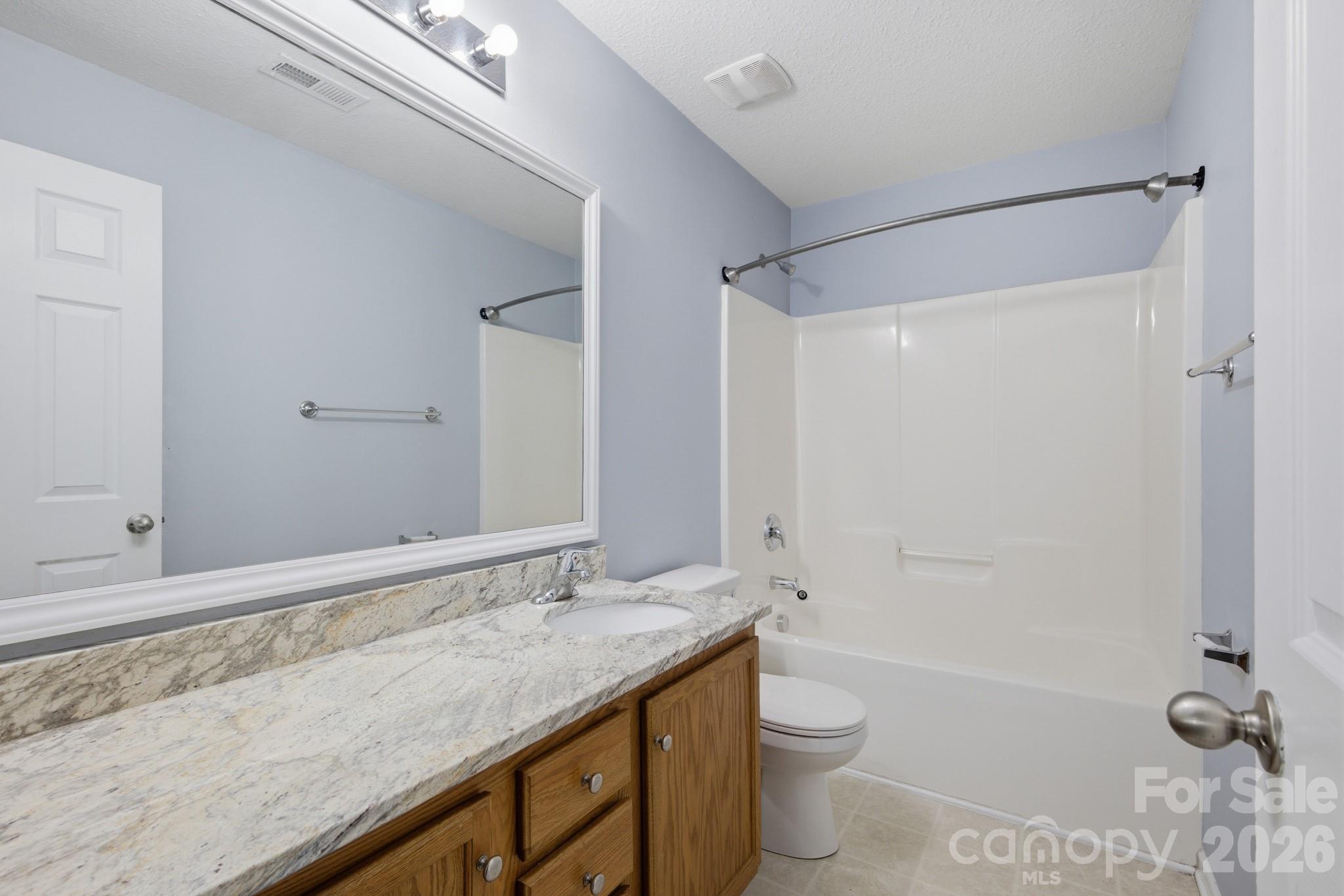 6404 Trotters Ridge Road Charlotte, NC 28227 - Photo 25 of 29 a bathroom with a granite countertop sink toilet and shower