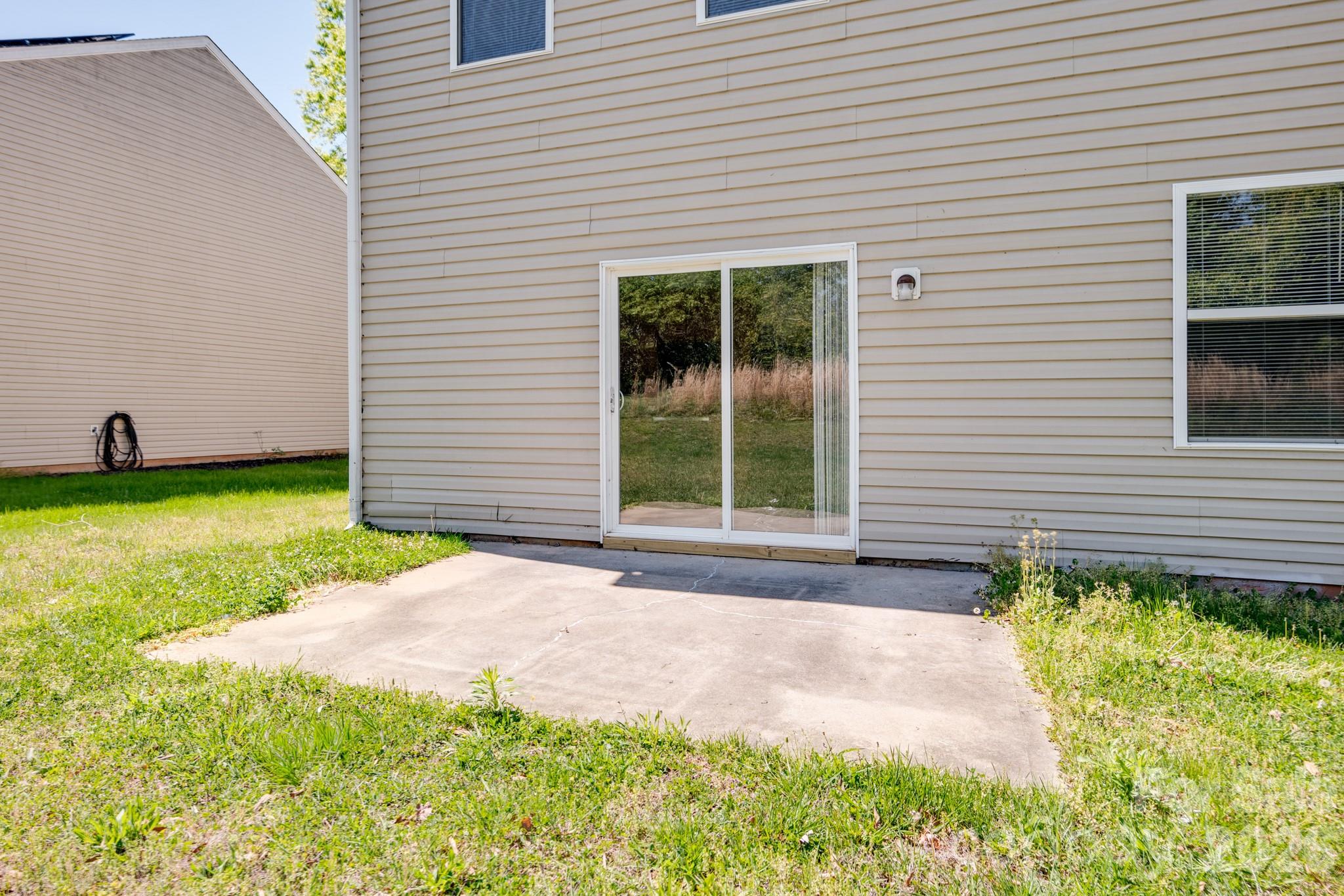 6404 Trotters Ridge Road Charlotte, NC 28227 - Photo 27 of 29 a front view of a house with a yard and garage
