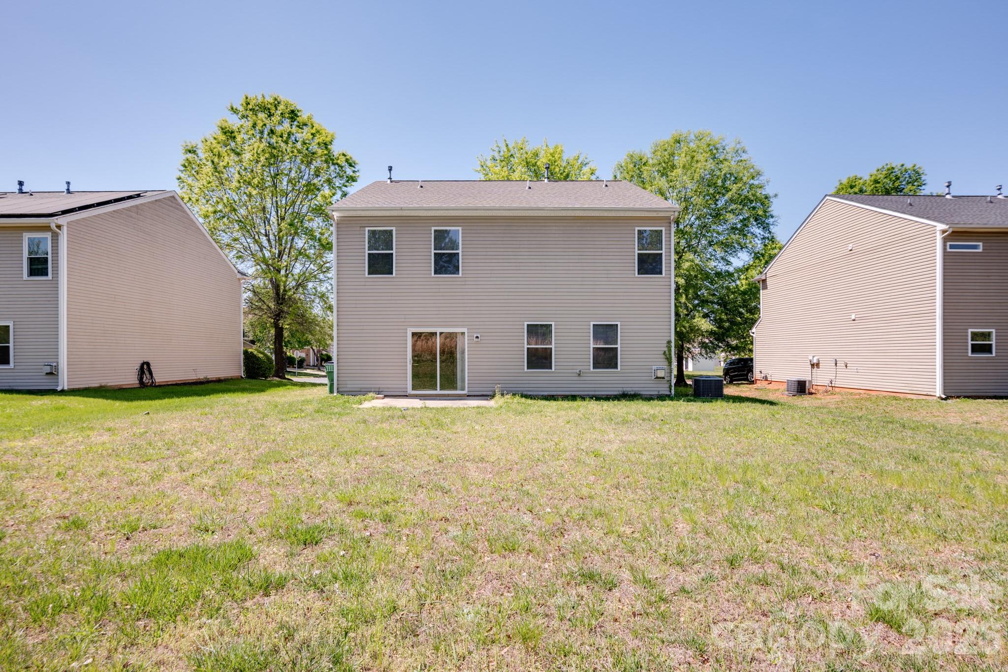 6404 Trotters Ridge Road Charlotte, NC 28227 - Photo 28 of 29 a view of a house with backyard and garage