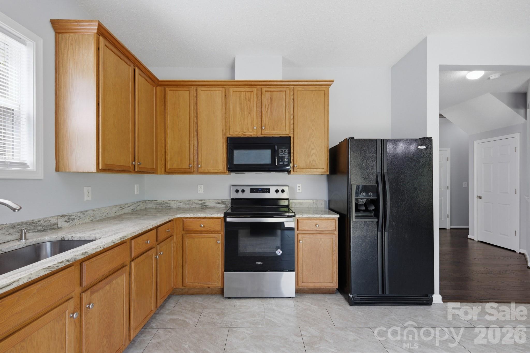 6404 Trotters Ridge Road Charlotte, NC 28227 - Photo 5 of 29 a kitchen with stainless steel appliances granite countertop a refrigerator and a sink