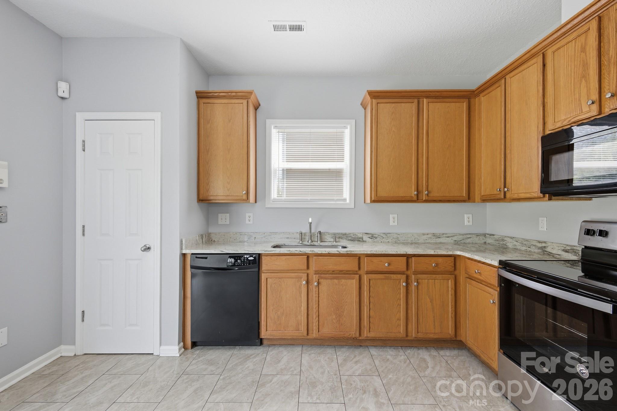 6404 Trotters Ridge Road Charlotte, NC 28227 - Photo 6 of 29 a kitchen with stainless steel appliances granite countertop a sink stove and cabinets
